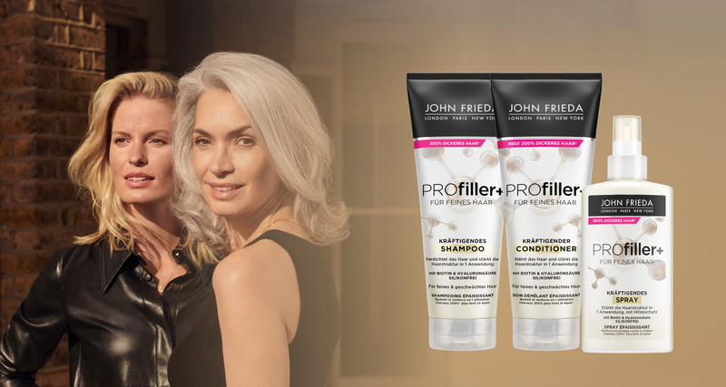 Zwei Frauen mit voluminösem Haar neben Shampoo, Conditioner und Spray der John Frieda PROfiller+ Produktlinie.